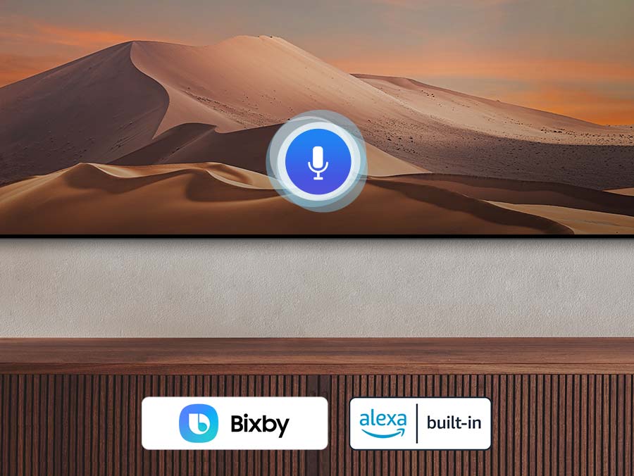 A person using the SolarCell Remote to give voice commands to the TV, with Bixby and Amazon Alexa logos displayed alongside.