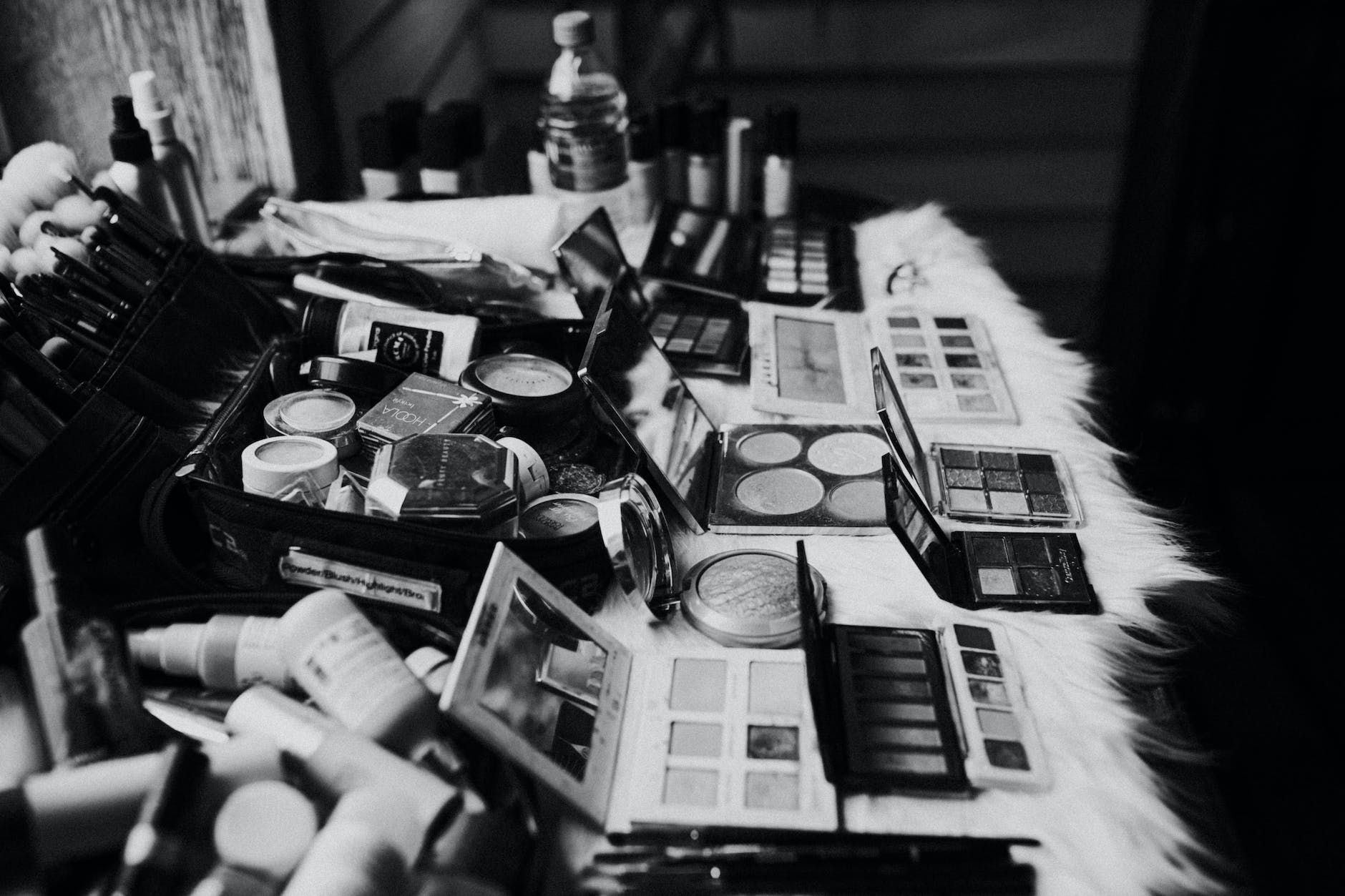 Black and white image of a very full selection of makeup and cosmetics by Beautifilipina. 